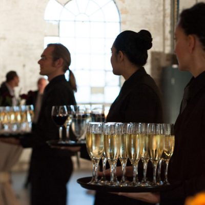 Forte Catering staff holding wine glasses