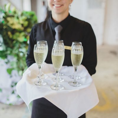 Forte catering staff carrying wine